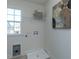 Bright laundry room with a window, washer hookups, and an abstract painting on the wall at 233 Steel Spring Rd # 24, Angier, NC 27501