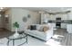 Bright, open-concept living area with modern decor and an adjacent kitchen with white cabinets at 233 Steel Spring Rd # 24, Angier, NC 27501