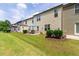 Manicured backyard with patio seating and views of a multi-story home with neutral vinyl siding at 238 Lynchwick Ln, Durham, NC 27703