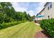 A spacious backyard with lush green grass, mature trees, and a patio area at 238 Lynchwick Ln, Durham, NC 27703