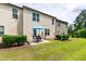 Backyard view of a multi-story home with a patio, lawn, and shade trees at 238 Lynchwick Ln, Durham, NC 27703