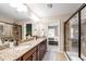 Well-lit bathroom featuring double sinks, granite countertops, and a tiled shower at 238 Lynchwick Ln, Durham, NC 27703