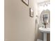 Stylish powder room featuring a pedestal sink, modern lighting, and decorative accents at 238 Lynchwick Ln, Durham, NC 27703