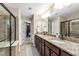 Well-lit bathroom featuring double vanity, granite countertops, walk-in closet, and tiled shower at 238 Lynchwick Ln, Durham, NC 27703