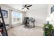 Bright bedroom featuring a ceiling fan, a large window, and a modern workspace at 238 Lynchwick Ln, Durham, NC 27703