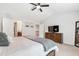 Spacious bedroom showcasing neutral tones, ceiling fan, a bed, and natural light at 238 Lynchwick Ln, Durham, NC 27703