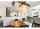 Inviting dining area featuring wood table, stylish chairs, modern lighting, and decorative exposed beam ceiling at 238 Lynchwick Ln, Durham, NC 27703