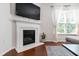 Elegant fireplace with white mantle, TV, and a cozy atmosphere at 238 Lynchwick Ln, Durham, NC 27703