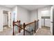 Upstairs landing with wood railing leading to bedrooms and laundry room at 238 Lynchwick Ln, Durham, NC 27703
