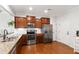Modern kitchen featuring stainless steel appliances, granite countertops, and ample wood cabinetry at 238 Lynchwick Ln, Durham, NC 27703