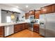 Modern kitchen featuring stainless steel appliances, granite countertops, and ample wood cabinetry at 238 Lynchwick Ln, Durham, NC 27703