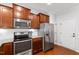 Modern kitchen featuring stainless steel appliances, granite countertops, and ample wood cabinetry at 238 Lynchwick Ln, Durham, NC 27703
