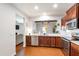 Modern kitchen featuring stainless steel appliances, granite countertops, and ample wood cabinetry at 238 Lynchwick Ln, Durham, NC 27703