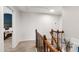 Bright staircase featuring wood banister, carpeted stairs, and access to the bedroom at 238 Lynchwick Ln, Durham, NC 27703