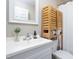 Clean bathroom with a stylish sink, a white mirror, and modern wooden storage cabinet, designed for comfort and functionality at 2423 Farthing St, Durham, NC 27704