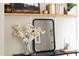 Close-up on a shelf in a bedroom displaying a mirror and flowers, enhancing the aesthetic appeal of the space at 2423 Farthing St, Durham, NC 27704