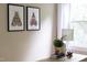 Modern desk decor complements natural light and framed artwork, creating a stylish workspace at 2423 Farthing St, Durham, NC 27704