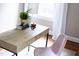 Bright desk features a light wood surface and thin black metal legs, adorned with decor at 2423 Farthing St, Durham, NC 27704