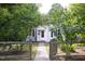 Charming home with gated front yard, blooming flowers and a welcoming pathway at 2423 Farthing St, Durham, NC 27704