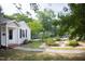 Charming home featuring a well-manicured front yard with lush landscaping and a quaint walkway at 2423 Farthing St, Durham, NC 27704