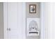 Charming hallway with vintage telephone, framed floral art, and a clean, bright aesthetic at 2423 Farthing St, Durham, NC 27704