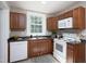 Functional kitchen with updated appliances, dark wood cabinets, and a bright window at 2423 Farthing St, Durham, NC 27704