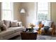 Living room featuring hardwood floors, a large rug and comfortable seating at 2423 Farthing St, Durham, NC 27704