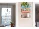 Stylish shelving unit with vibrant blue, peach, and white shelves displaying decorative items, adding character to the home's interior at 2423 Farthing St, Durham, NC 27704