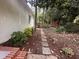 Scenic backyard featuring a brick-lined walkway, mature trees and lush landscaping at 2428 Perkins Rd, Durham, NC 27705