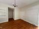 Versatile bedroom with hardwood floors, classic lighting fixture, and ample closet space at 2428 Perkins Rd, Durham, NC 27705