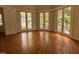 Bright living room boasting hardwood floors and multiple French doors offering views of the yard at 2428 Perkins Rd, Durham, NC 27705
