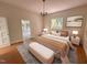 Serene main bedroom features a neutral palette, hardwood floors, and ample natural light at 2428 Perkins Rd, Durham, NC 27705