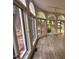 Sun Room featuring large arched windows, hardwood floors, and scenic views at 2428 Perkins Rd, Durham, NC 27705