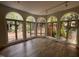 Sun Room featuring arched windows, hardwood floors, and backyard views at 2428 Perkins Rd, Durham, NC 27705