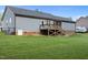 A spacious backyard features a charming deck, well-maintained lawn, and mature landscaping perfect for relaxing or entertaining at 244 Lasswade Ct, Zebulon, NC 27597