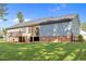 A spacious backyard features a charming deck, well-maintained lawn, and mature landscaping perfect for relaxing or entertaining at 244 Lasswade Ct, Zebulon, NC 27597