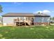 A spacious backyard features a charming deck, well-maintained lawn, and mature landscaping perfect for relaxing or entertaining at 244 Lasswade Ct, Zebulon, NC 27597