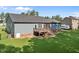A spacious backyard features a charming deck, well-maintained lawn, and mature landscaping perfect for relaxing or entertaining at 244 Lasswade Ct, Zebulon, NC 27597