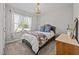 Cozy bedroom with a comfortable bed, soft carpet, chandelier and natural light from the window at 244 Lasswade Ct, Zebulon, NC 27597