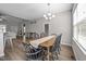 Inviting dining room featuring a classic wooden table with black chairs and hardwood flooring at 244 Lasswade Ct, Zebulon, NC 27597
