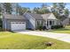 Well-maintained home showcasing an attached two-car garage, a concrete driveway and beautiful landscaping at 244 Lasswade Ct, Zebulon, NC 27597