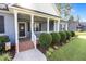 Inviting front porch featuring classic columns, tidy landscaping, and a welcoming entrance at 244 Lasswade Ct, Zebulon, NC 27597