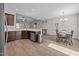 Bright kitchen featuring a breakfast bar, dark cabinetry, and stainless steel appliances at 244 Lasswade Ct, Zebulon, NC 27597