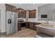 Beautiful kitchen with stainless steel appliances, dark wood cabinetry, and granite countertops at 244 Lasswade Ct, Zebulon, NC 27597