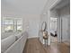 Inviting living room showcasing hardwood floors, access to a bedroom, and a bright window at 244 Lasswade Ct, Zebulon, NC 27597
