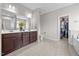 Stylish main bathroom featuring double vanity, a walk-in closet, and a separate toilet area at 244 Lasswade Ct, Zebulon, NC 27597