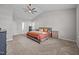 Comfortable main bedroom with ample space, soft carpet, a ceiling fan and an attached bathroom at 244 Lasswade Ct, Zebulon, NC 27597