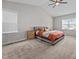 Spacious main bedroom featuring a cozy bed, a ceiling fan and natural light from the window at 244 Lasswade Ct, Zebulon, NC 27597