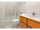 Standard bathroom with a shower and tub combination, a toilet, and a wooden vanity at 252 Fox Ridge, Pittsboro, NC 27312
