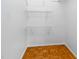 Small closet design with mounted wire shelves and hardwood floors at 252 Fox Ridge, Pittsboro, NC 27312